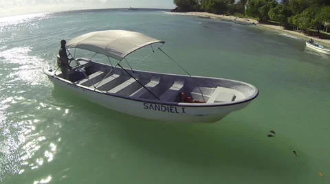 Man docks small boat to pier in tropics Stock Footage 35261780