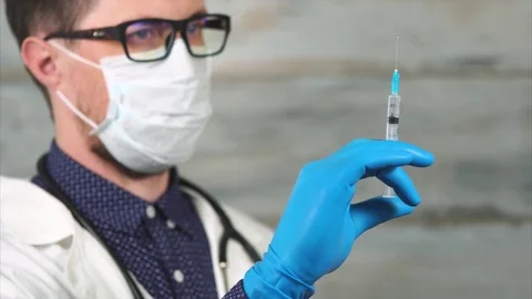 Man doctor preparing to make injection Stock Footage 76768498