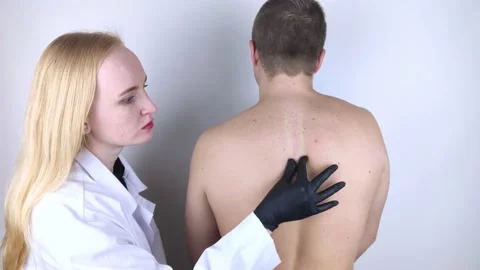 A man at the doctor's appointment with back pain. Treatment of spinal deformity  Stock Footage 148750944