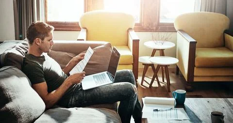 Man, document and remote work from home with a laptop, planning and journalist 库存照片