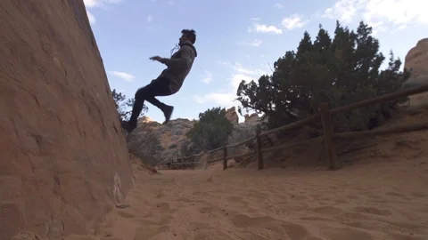 Man Does 2 step Wall Flip Hand Plant on Desert Rocks Slow Motion Stock Footage 98862708