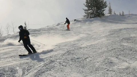 The man does alpine skiing as second skier is standing and looking around Stock Footage 112019944