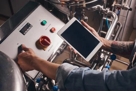 Man does beer brewery processing at the plant. Stock Photos