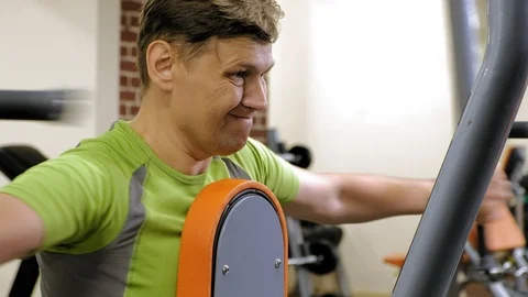 Man does a butterfly exercise on the simulator in a fitness studio.healthy Stock Footage 111509610