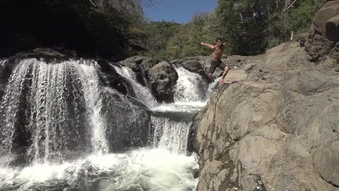 Man Does Double Twist Back Flip Full off of Waterfall Stock Footage 85130933
