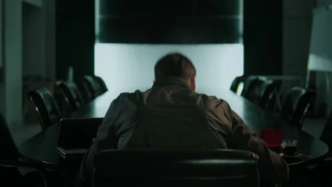 A man does drugs in empty office at night. Video stock 168323392