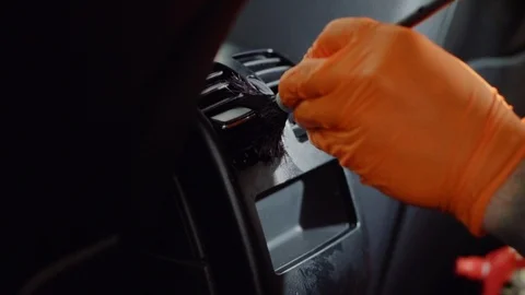 Man does dry cleaning of the car Stock Footage 93475485