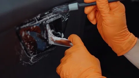 Man does dry cleaning of the car Stock Footage 93480580