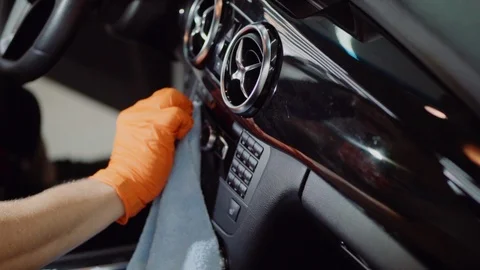 Man does dry cleaning of the car Stock Footage 93486832