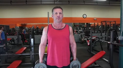 Man Does Dumbbell Curls At The Gym Stock-Footage 61576719