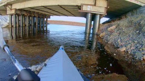 Man does expeditionary kayaking sailing in canoe on river Stock Photos