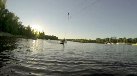 Man does extreme stunts on a wakeboard in slow motion on the lake Stock Footage 56199034