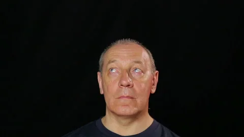 A man does eye exercises by looking from corner to corner Stock Footage 112754937