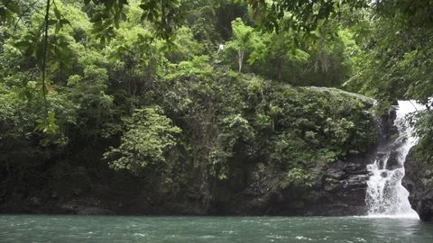 Man does Flip off 15 Meter Cliff Jump in Bali Jungle Waterfall Slow Motion Stock Footage 106783617