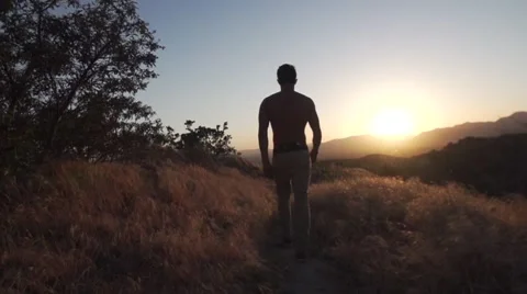Man does a Flip and Walks into Sunset along Mountain line in Slow Motion. Stock Footage 50147301