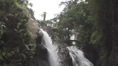 Man Does Gainer Flip Off Waterfall in Bali Stock Footage 106783642