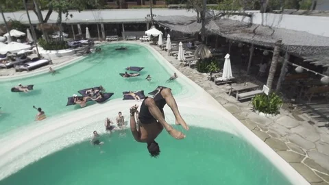 Man Does Handstand Cast Flip at Bali Pool Club Slow Motion Stock Footage 106151823