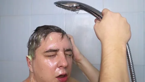 Man does head scrub. Dark-haired young man applies a scalp scrub to combat dandr Stock Footage 256219052