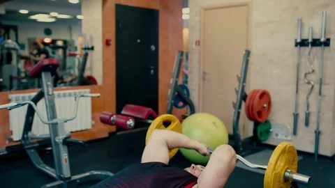 Man Does Heavy Bench press At Gym Stock Footage 81429054
