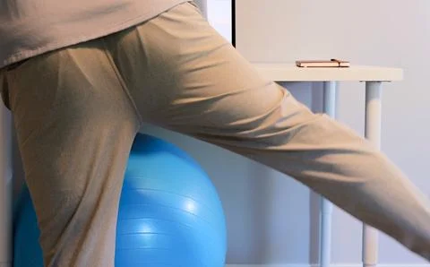 Man Does IT Band Physical Therapy at Standing Desk Stock Photos