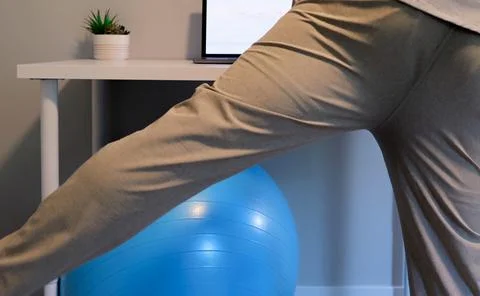 Man Does IT Band Physical Therapy at Standing Desk Stock Photos