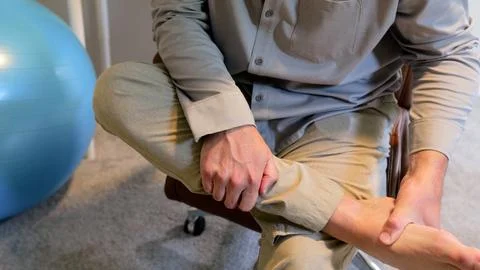 Man Does IT Band Physical Therapy at Standing Desk Stock Photos