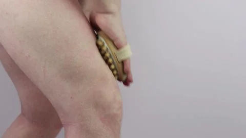 Man does a knee massage with a massage brush Stock Footage 151590347