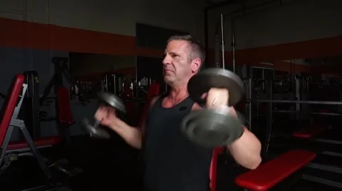 Man Does Military Shoulder Press At The Gym Stock-Footage 61576770