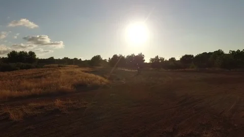 A man does motorally at sunset. About extreme sports, adrenaline, dust Stock Footage 70935927