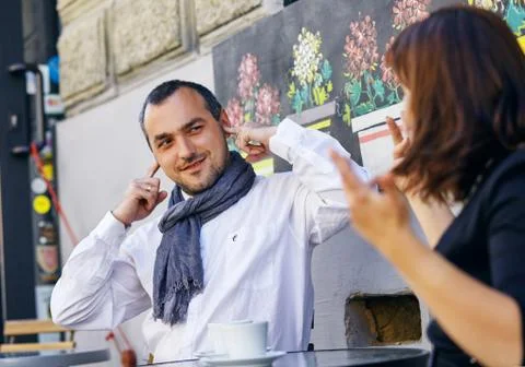 Man does not want to listen to a woman. He closes his ears. Concept on gender Stock Photos
