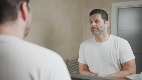 Man does OK sign to himself in mirror Video stock 262076931