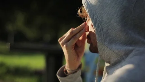 Man does pranayama breathing exercises outdoors sunny morning slow motion side Stock Footage 79975248