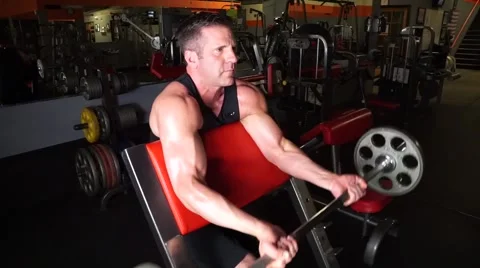 Man Does Preacher Curls At The Gym Stock-Footage 61576807