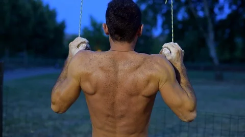 A man does a pull up Stock Footage 92494603