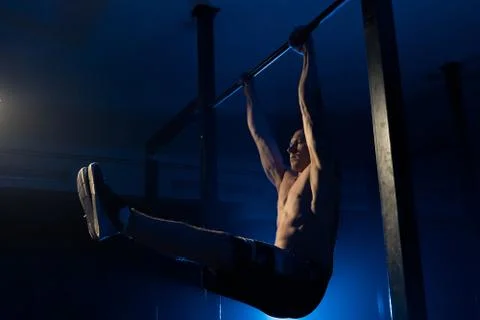 The man does pull-ups on the crossbar. Health. sport Stock Photos