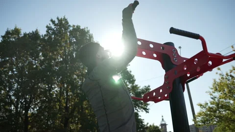 A man does pull-ups on a horizontal bar Stock Footage 224317266