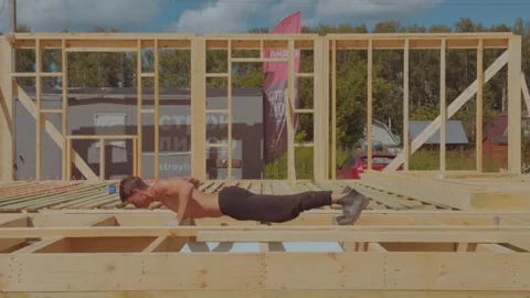 A man does push-ups on a construction site, training on a construction site Stock Footage 338251702