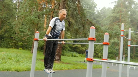 A man does push-ups on parallel bars Video stock 66543948