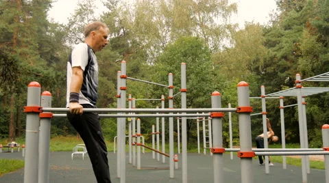A man does push-ups on parallel bars Video stock 66549154