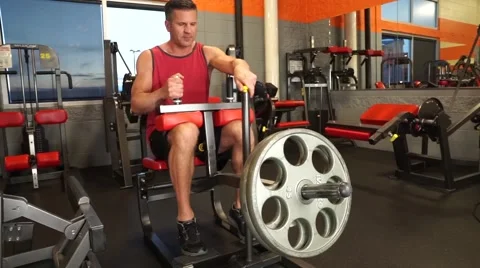 Man Does Seated Calf Raises At The Gym Video stock 61576801