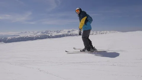 Man does ski tricks on a track in the big mountains among beautiful  landscape Stock Footage 127589534