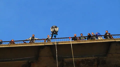 Man does somersaults in a jump from the bridge Stock Footage 37220979