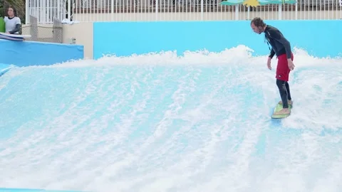 Man Does Surfboard Tricks on Indoor Wave Pool Stock-Footage 158345296