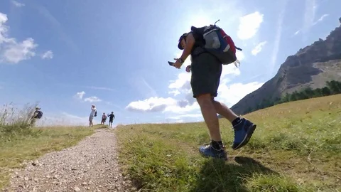 A Man does Trek on an open wide vale between Alps, backlight vr360 effects Stock Footage 114423885
