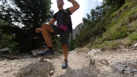 A Man does Trek on an path between Alpine forest, vr360 effects Stock Footage 114075516