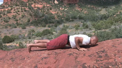 Man Does Yoga Poses under Thunder Mountain Sedona Arizona Stock Footage