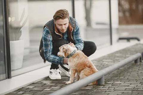 Man with a dog in a city Stock Photos