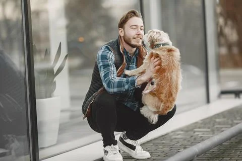Man with a dog in a city Stock Photos