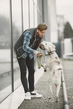 Man with a dog in a city Stock Photos
