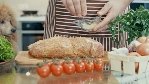 Man with dog preparing meat in the kitchen . Stock Footage 85789494